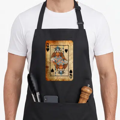 Youth queen apron - Mirrored queen playing card in brown blue white and black with Q and heart symbols — shown on a black cotton canvas apron against a white background