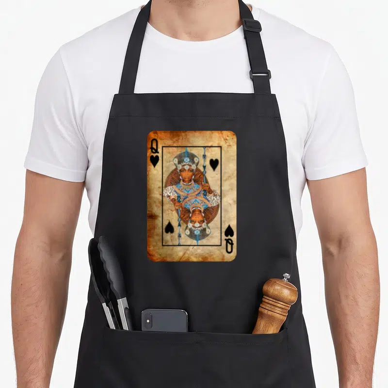 Youth queen apron - Mirrored queen playing card in brown blue white and black with Q and heart symbols — shown on a black cotton canvas apron against a white background