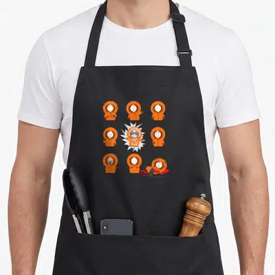 Kenny south girl apron - Nine cartoon figures in orange parkas arranged in a grid with a central skeletal figure inside — shown on a black cotton canvas apron against a white background