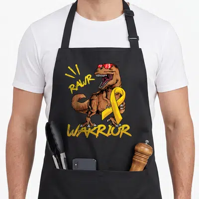 Rex ribbon apron - Brown T-Rex wearing red sunglasses and holding a yellow ribbon with RAWR WARRIOR text in yellow — shown on a black cotton canvas apron against a white background