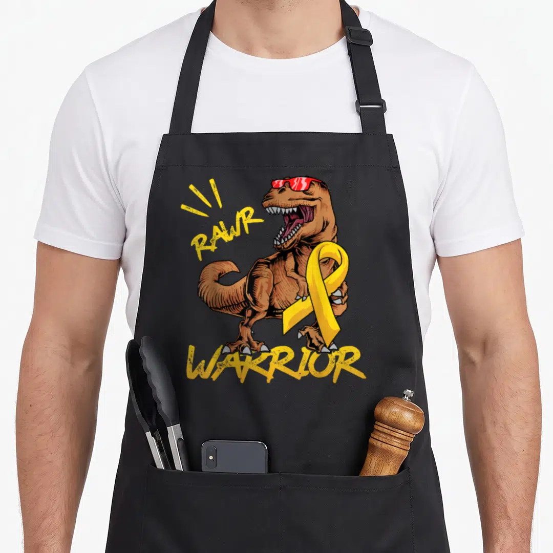 Rex ribbon apron - Brown T-Rex wearing red sunglasses and holding a yellow ribbon with RAWR WARRIOR text in yellow — shown on a black cotton canvas apron against a white background