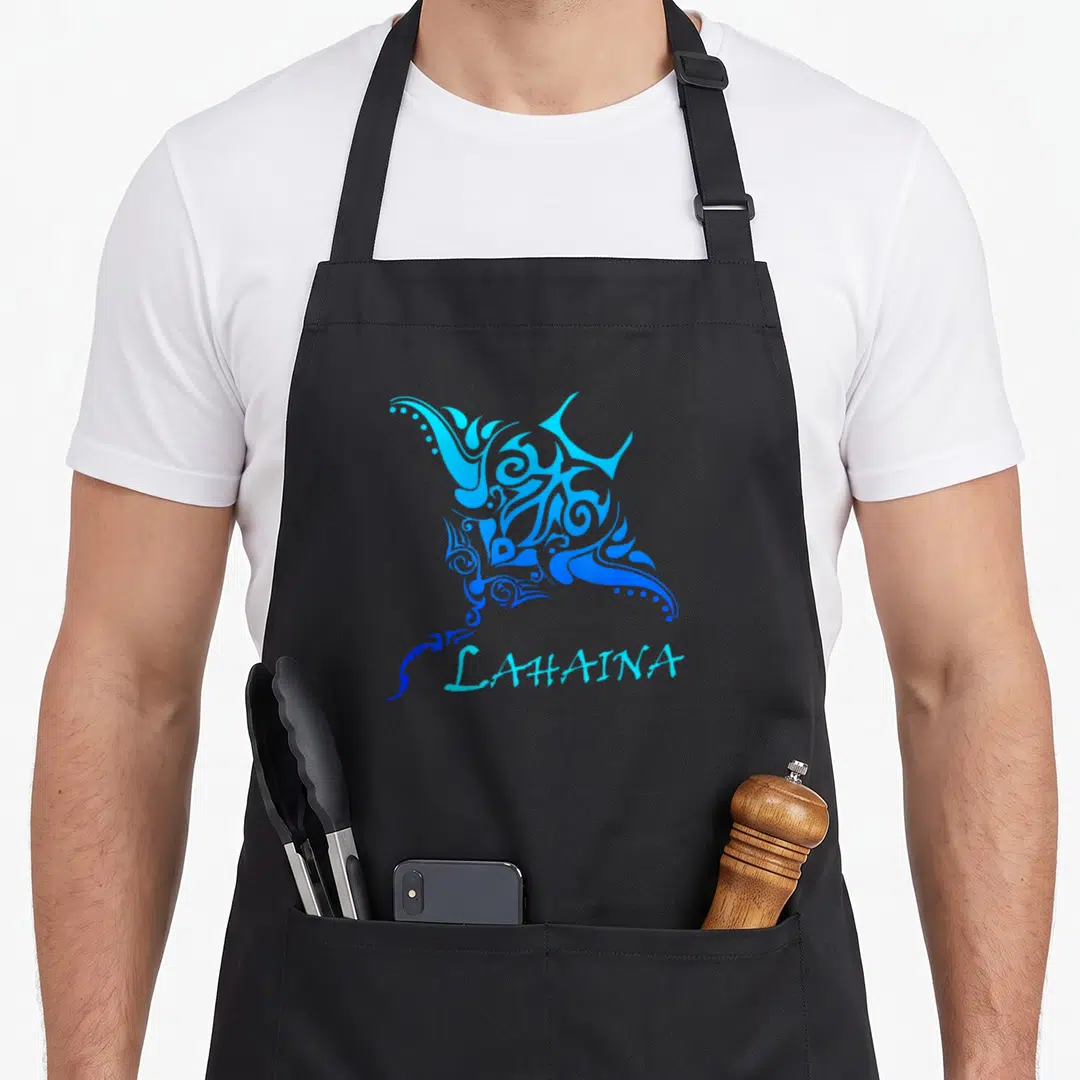 Lahaina tattoo apron - Blue tribal stingray swirls above light blue LAHAINA text — shown on a black cotton canvas apron against a white background