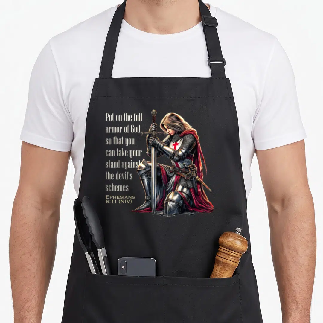 Christian knight templar apron - Kneeling knight with sword and Ephesians 6:11 text in silver red white blonde — shown on a black cotton canvas apron against a white background