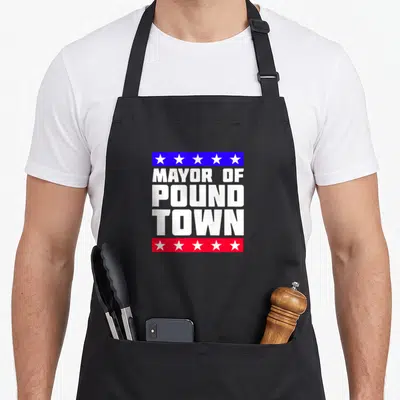 Pound mayor apron - MAYOR OF POUND TOWN text in white between blue and red bars with white stars — shown on a black cotton canvas apron against a white background