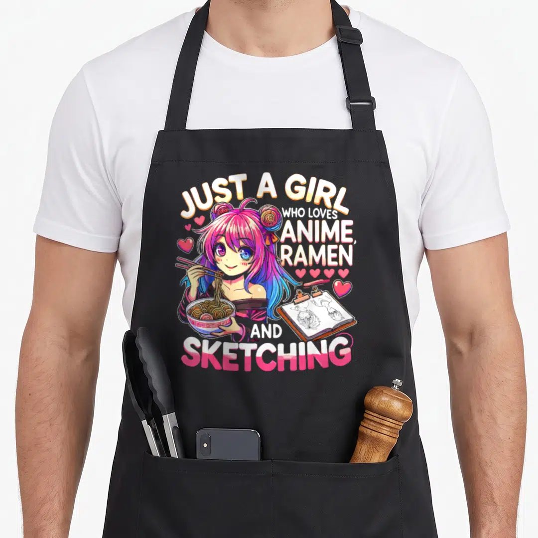 Sketching japan apron - Anime girl holding ramen bowl and sketchbook with text JUST A GIRL WHO LOVES ANIME RAMEN — shown on a black cotton canvas apron against a white background