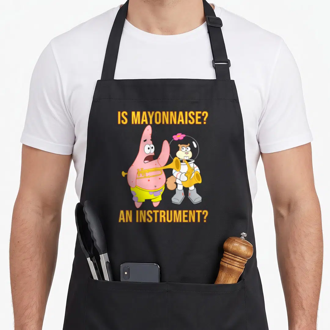 Patrick mayonnaise apron - Patrick Star and Sandy Cheeks holding brass instruments with text IS MAYONNAISE? — shown on a black cotton canvas apron against a white background