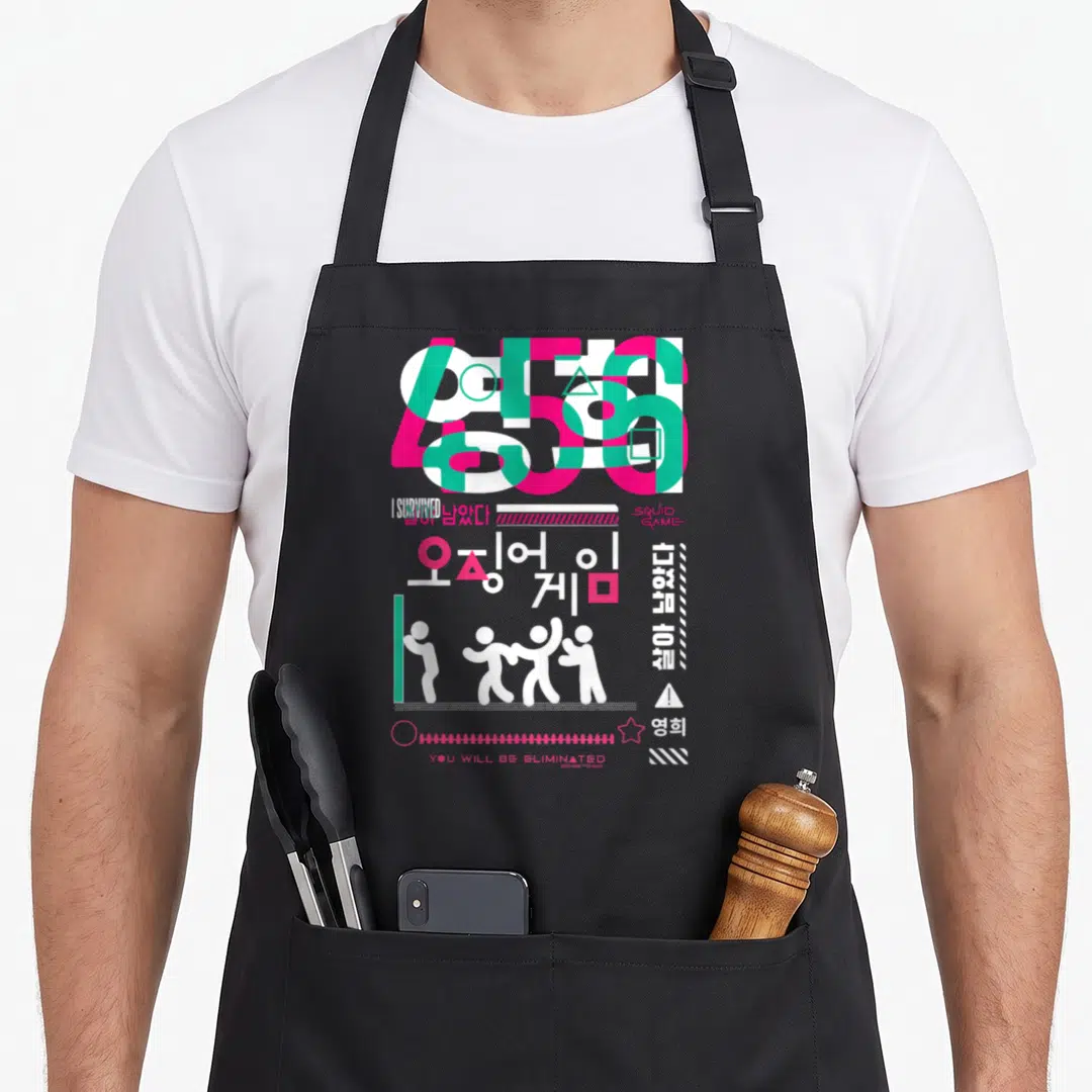 Eliminated crazy squid lady apron - Pink green white typography with numbers 456 I survived and squid game text — shown on a black cotton canvas apron against a white background