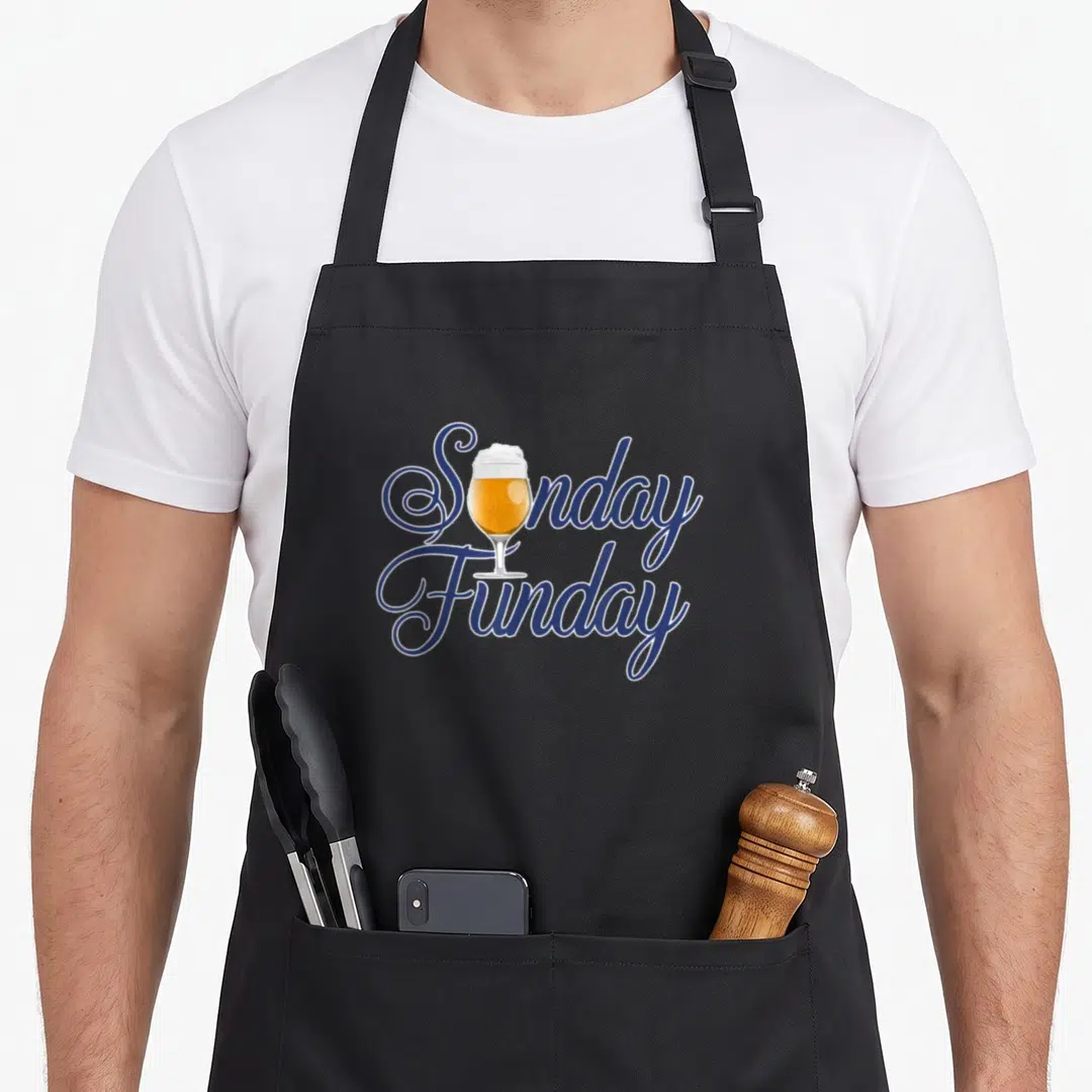 Funny funday sunday apron - Blue script text Sunday Funday with a gold beer glass replacing the letter u — shown on a black cotton canvas apron against a white background
