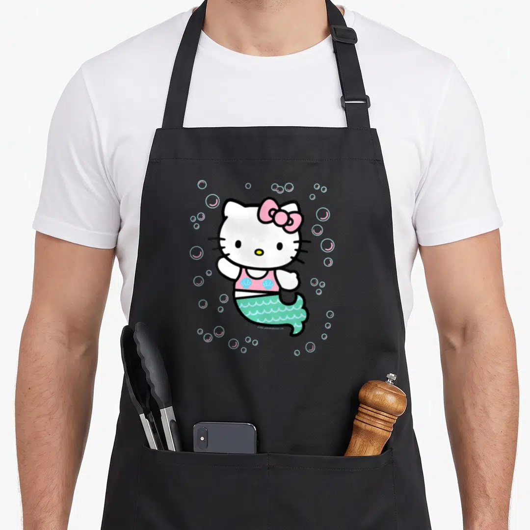 Funny mermaid apron - Hello Kitty mermaid in pink top and mint tail surrounded by blue and pink bubbles — shown on a black cotton canvas apron against a white background