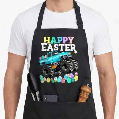 Monster easter egg apron - Blue monster truck with multicolored HAPPY EASTER text and scattered decorated eggs — shown on a black cotton canvas apron against a white background