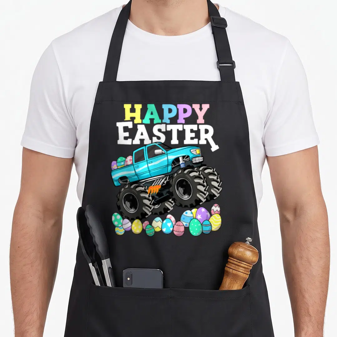 Monster easter egg apron - Blue monster truck with multicolored HAPPY EASTER text and scattered decorated eggs — shown on a black cotton canvas apron against a white background