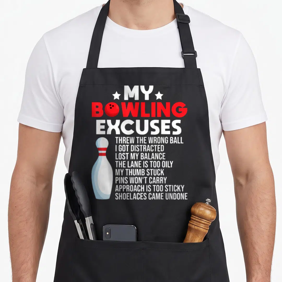 Excuse bowling apron - Stacked white text listing bowling excuses with red title and bowling pin graphic — shown on a black cotton canvas apron against a white background