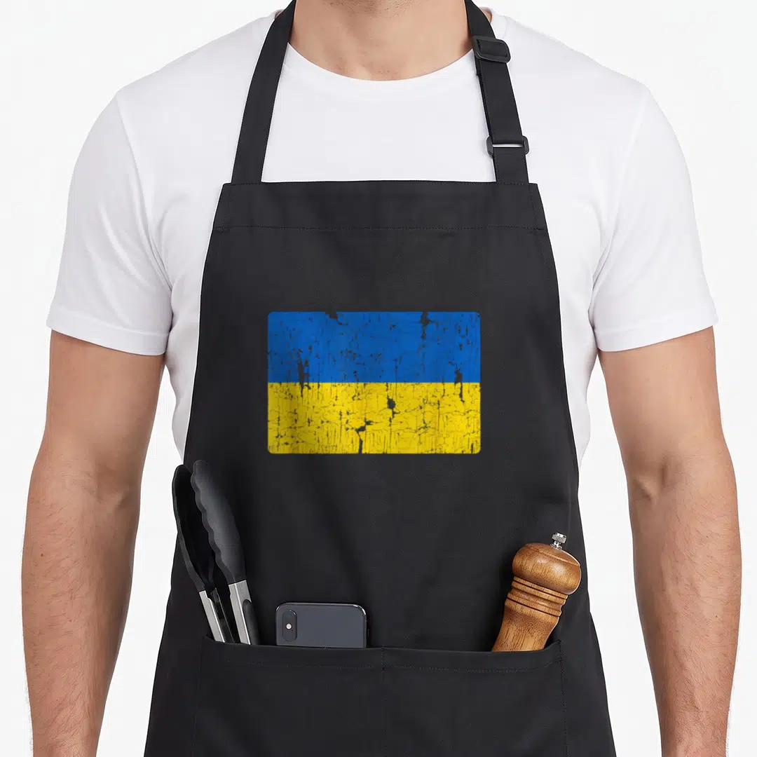 Flag ukraine ukrainian aprons - Distressed blue and yellow flag rectangle printed on black fabric — shown on a black cotton canvas apron against a white background