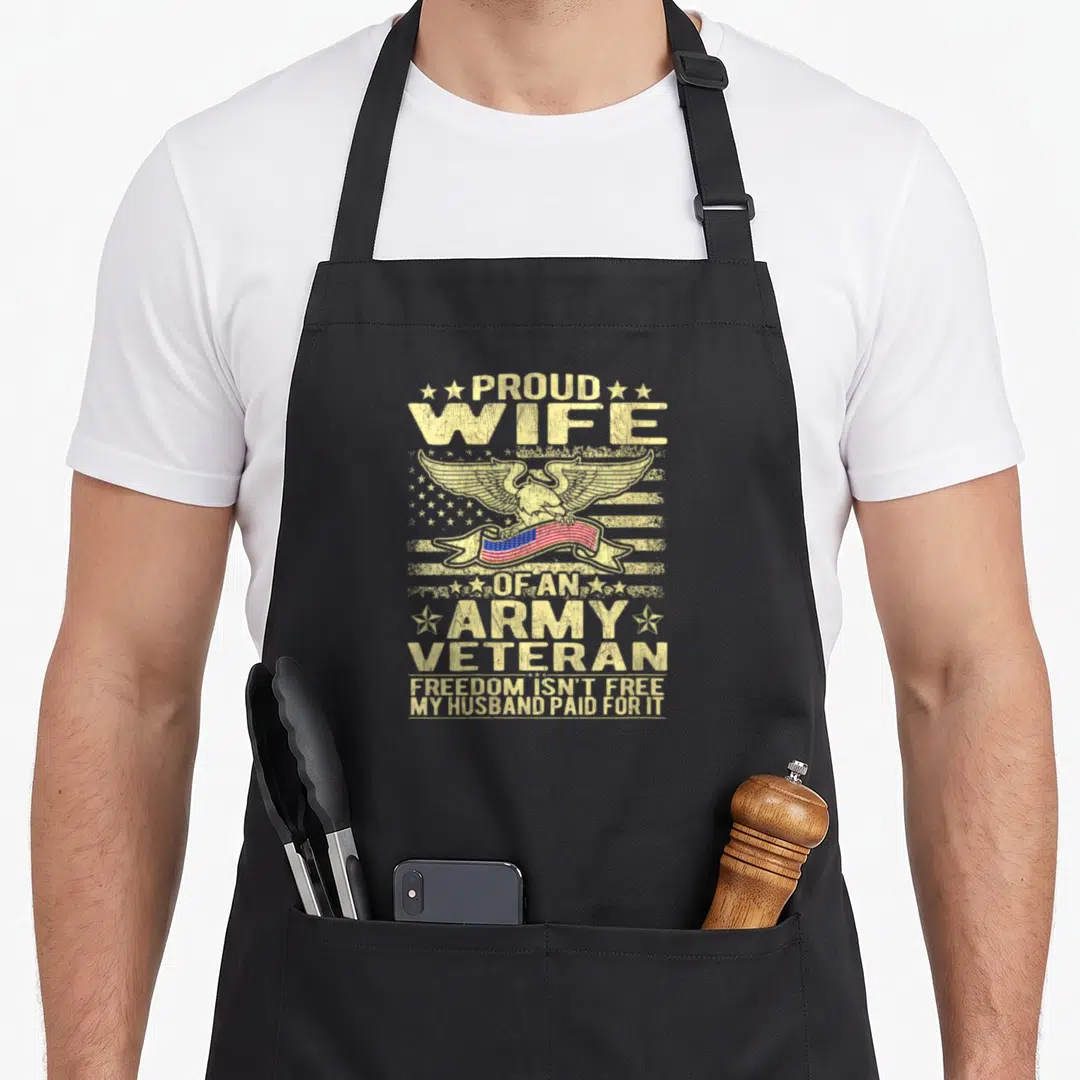 Freedom wife apron - Distressed eagle holding US flag ribbon with stacked text Proud Wife Of An Army Veteran Freedom — shown on a black cotton canvas apron against a white background