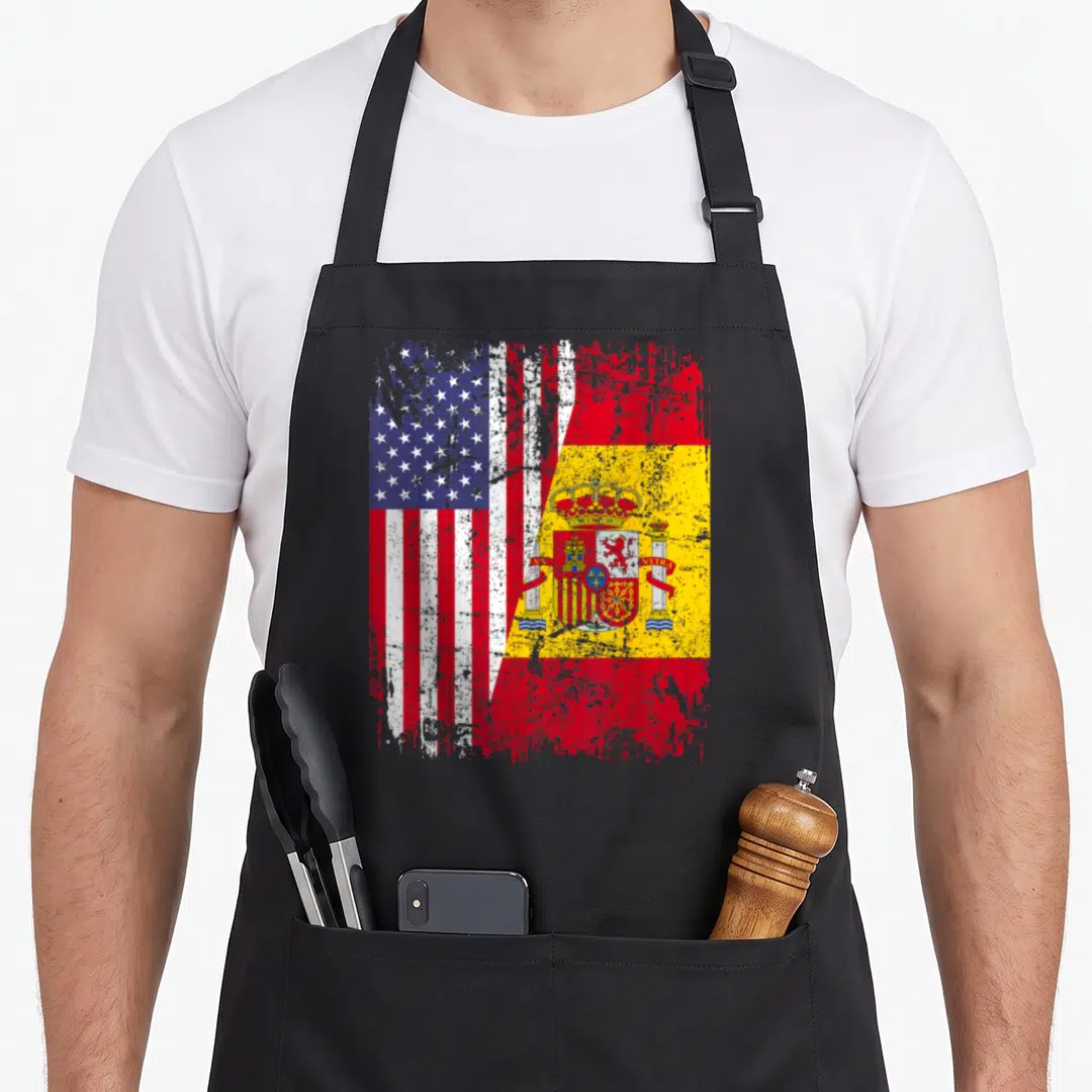 Spanish american flag apron - Merged USA and Spanish flags with distressed red white blue yellow texture — shown on a black cotton canvas apron against a white background