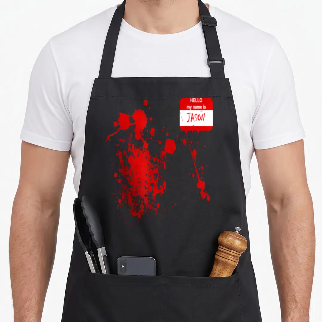 Jason halloween apron - Red and white name tag reading Hello My Name Is Jason with blood splatters — shown on a black cotton canvas apron against a white background