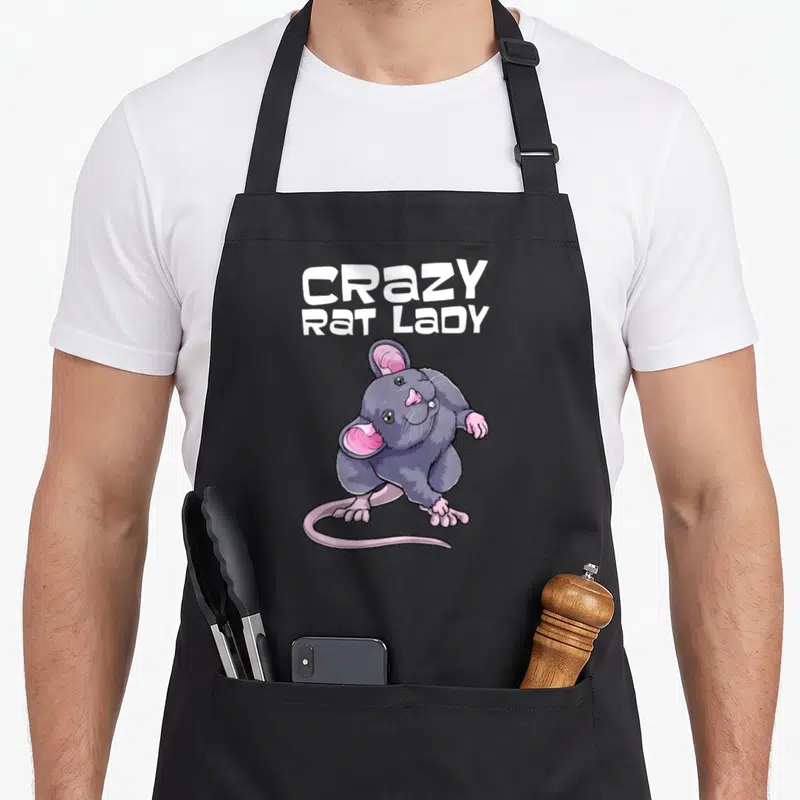 Animal obsessed rat lady apron - Cartoon grey rat with pink ears and tail below stacked white text reading CRAZY RAT — shown on a black cotton canvas apron against a white background