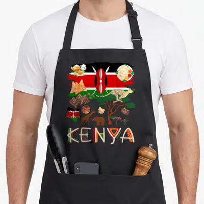 Kenya food aprons - Collage of Kenyan flag, cheetah, giraffe, food, and decorative KENYA text in red green black — shown on a black cotton canvas apron against a white background