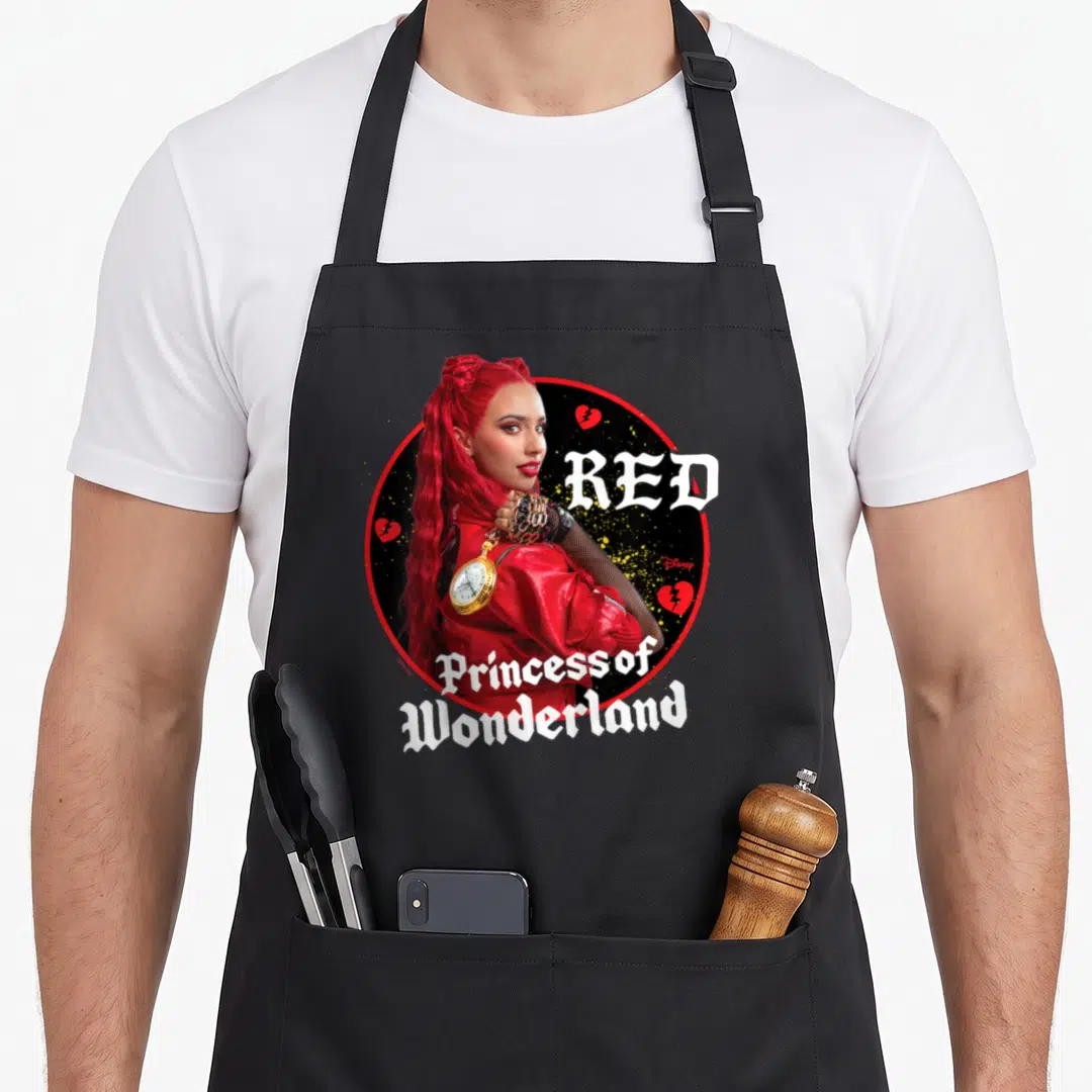 Descendant princess apron - Woman with red hair in red jacket inside black circle with red broken hearts and white — shown on a black cotton canvas apron against a white background