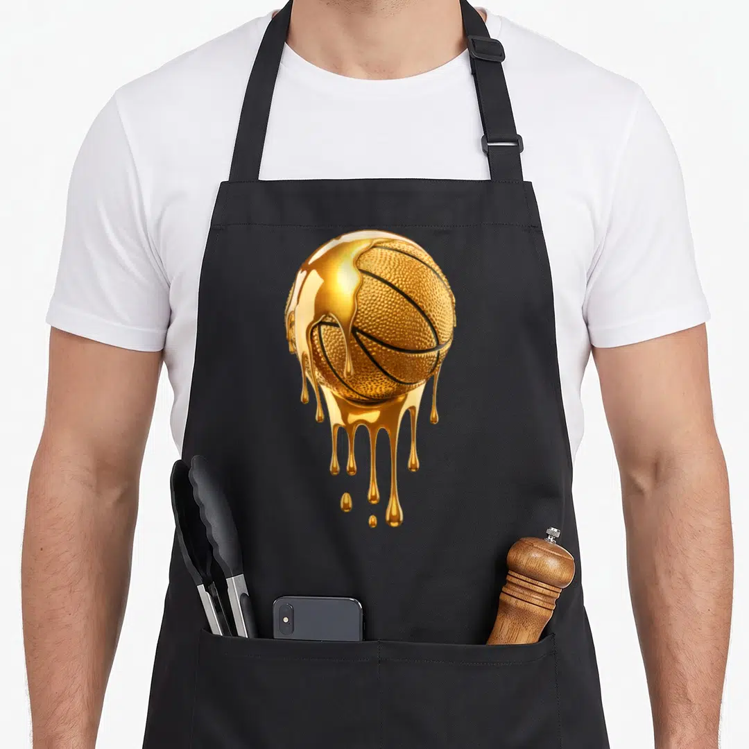 Dripping trendy apron - Realistic gold basketball with liquid dripping down the surface — shown on a black cotton canvas apron against a white background