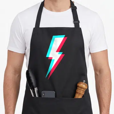 Symbol lighting bolt apron - White lightning bolt with cyan and red offset shadows on grey background — shown on a black cotton canvas apron against a white background