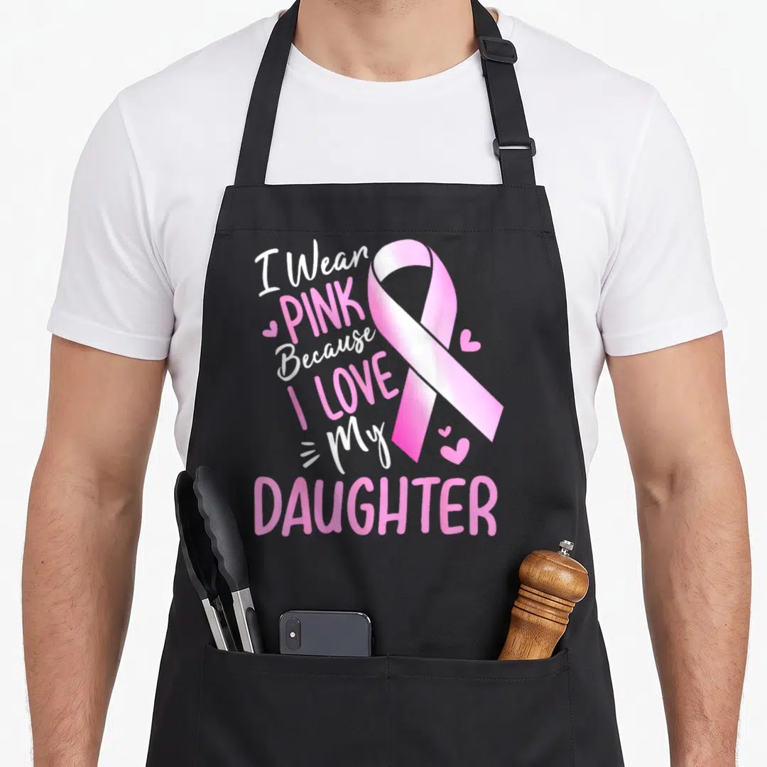 Funny daughter breast cancer awareness aprons - Pink ribbon with I Wear PINK Because I LOVE My DAUGHTER text and small — shown on a black cotton canvas apron against a white background