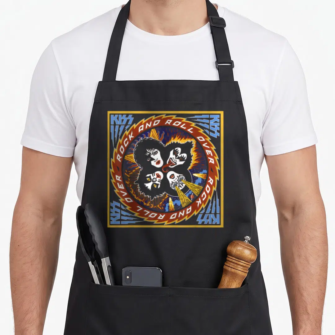 Rock over officially apron - Four faces in red circle with Rock and Roll Over text and KISS lightning bolts — shown on a black cotton canvas apron against a white background