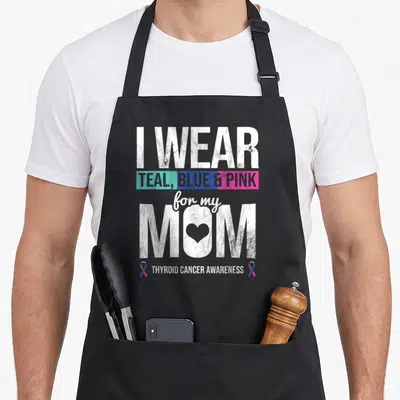 Blue thyroid ribbon apron - Stacked text I WEAR TEAL BLUE PINK for my MOM with heart and awareness ribbons — shown on a black cotton canvas apron against a white background