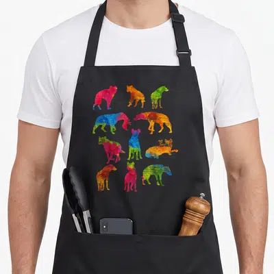 Hyena colorful aprons - Ten watercolor dog silhouettes in blue red yellow green orange and pink scattered in four rows — shown on a black cotton canvas apron against a white background