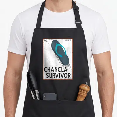 Joke spanish aprons - Flying blue flip flop with 100 level up chancla survivor text and orange border — shown on a black cotton canvas apron against a white background