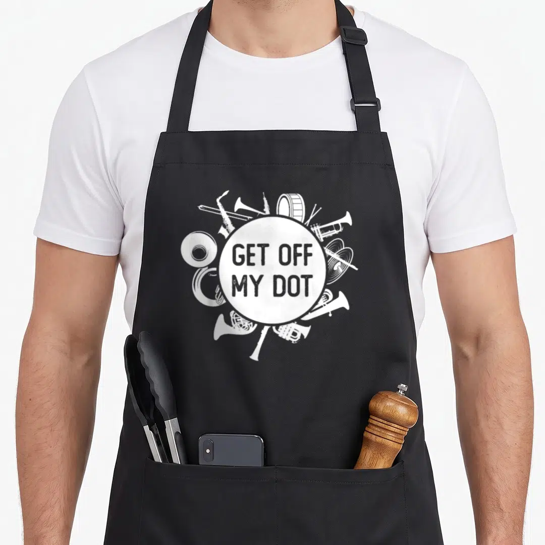 Dot camp chef apron - White musical instruments surround a circle with Get Off My Dot text in distressed style — shown on a black cotton canvas apron against a white background