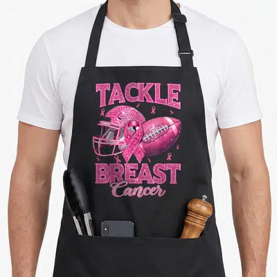 Football ribbon apron - Pink glitter football helmet and ribbon with TACKLE BREAST Cancer text — shown on a black cotton canvas apron against a white background