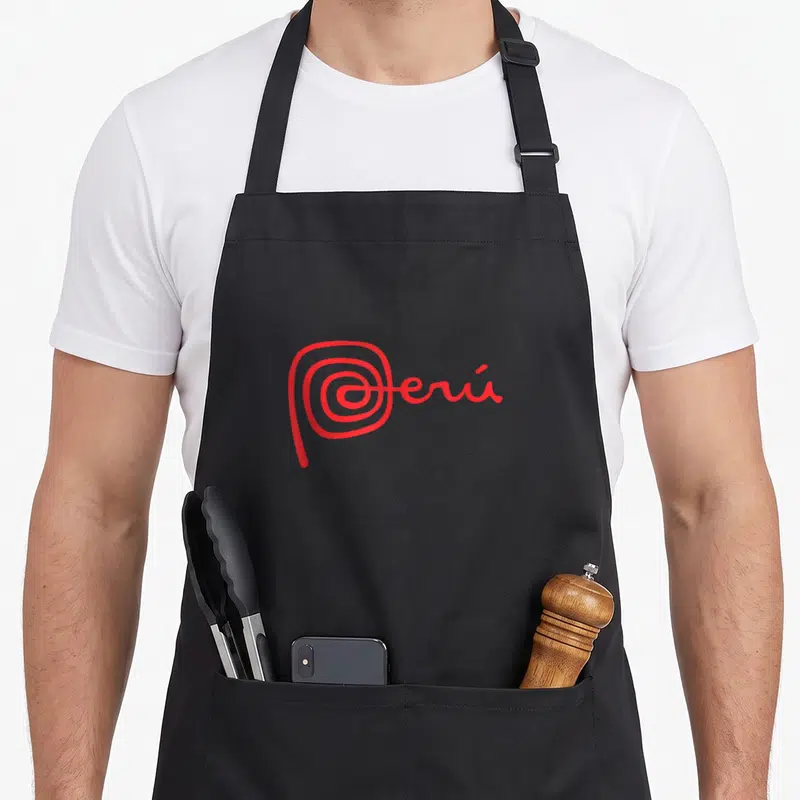 Peruvian line apron - Red stylized text Peru with spiral P on grey background — shown on a black cotton canvas apron against a white background