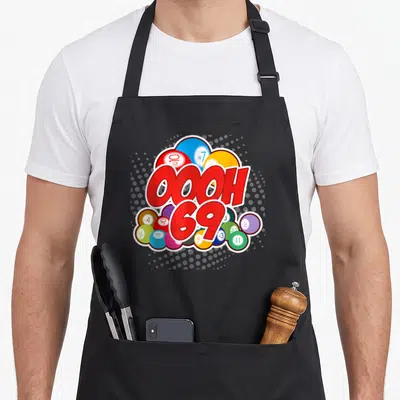 Ooooh bingo aprons - Red OOOH 69 text overlapping colorful numbered lottery balls on grey halftone background — shown on a black cotton canvas apron against a white background