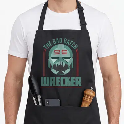 Wrecker novelty apron - Light blue helmet with red lines and text The Bad Batch Wrecker — shown on a black cotton canvas apron against a white background