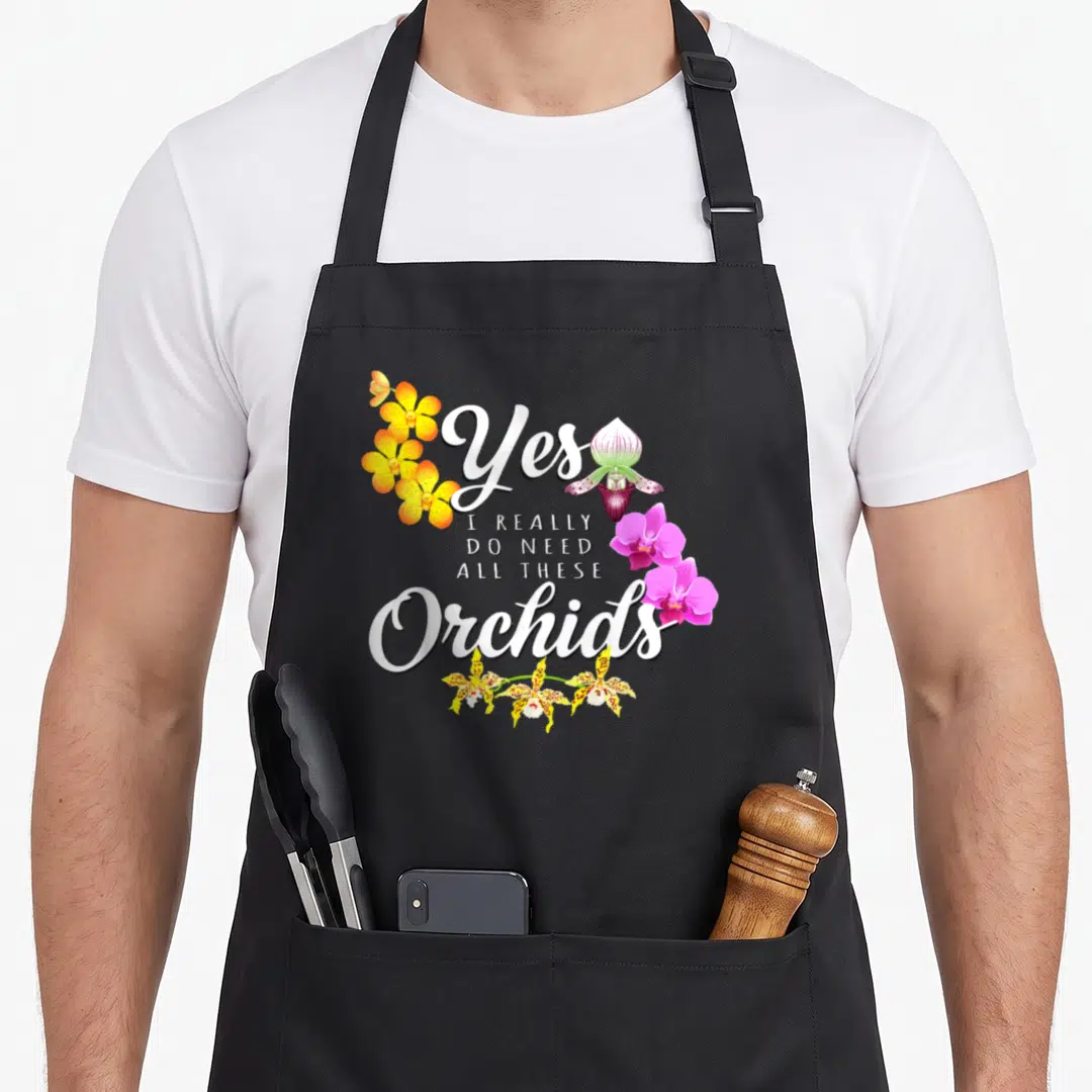 Orchid do i need an apron - Stacked white text Yes I Really Do Need All These Orchids with yellow, purple, pink flowers — shown on a black cotton canvas apron against a white background