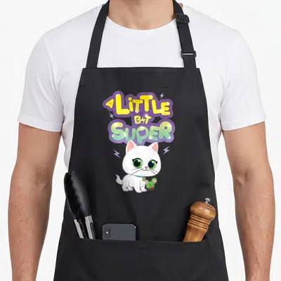 Bitsy junior apron - Stacked A Little Bit Super text above white cat and green mouse with lightning bolts — shown on a black cotton canvas apron against a white background