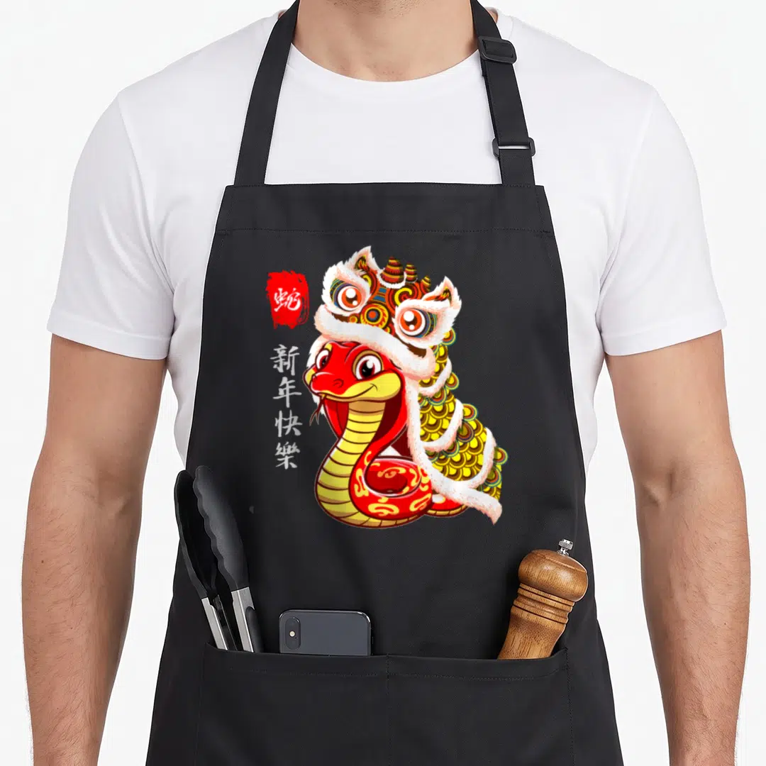 Dance lion apron - Red snake wearing lion dance costume with vertical Chinese New Year text — shown on a black cotton canvas apron against a white background