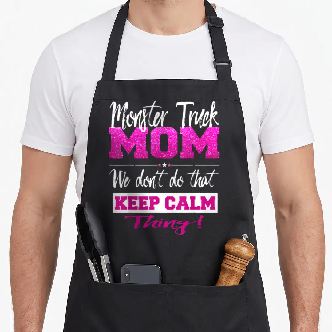 Car mother truck apron - Pink and white typography reading Monster Truck MOM We don't do that Keep Calm Thing with stars — shown on a black cotton canvas apron against a white background