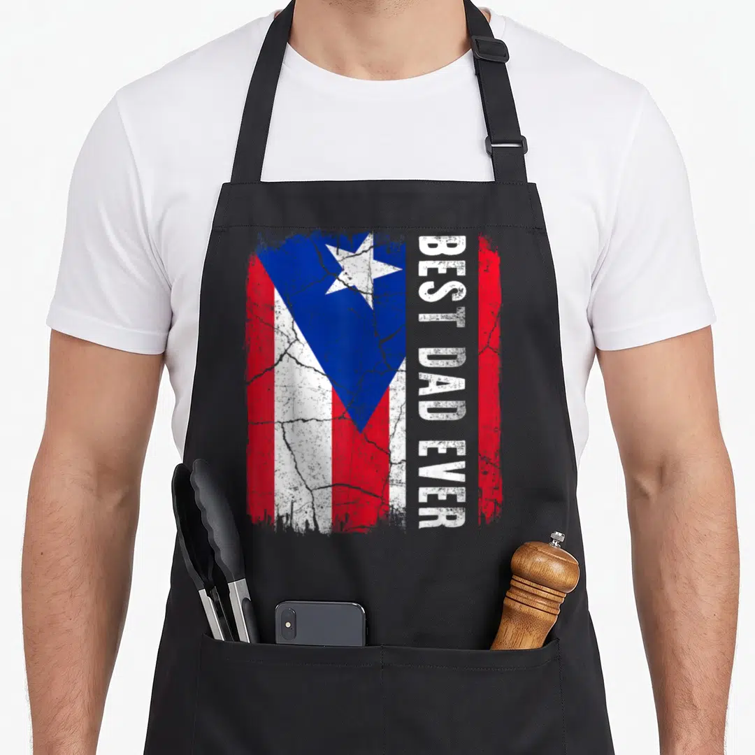 Rico father day apron - Distressed Puerto Rican flag with vertical BEST DAD EVER text in red white blue — shown on a black cotton canvas apron against a white background