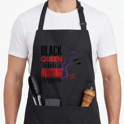 Queen nurse apron - Stacked text Black Queen with a Nursing degree next to woman profile with purple crown — shown on a black cotton canvas apron against a white background