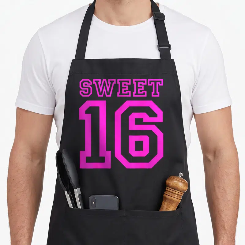 Sixteen hot pink apron - Pink Sweet 16 typography design stacked vertically on grey background — shown on a black cotton canvas apron against a white background
