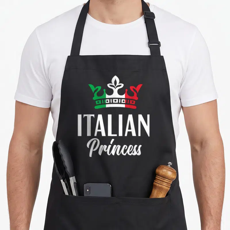 Princess italy apron - Crown in white green and red above stacked Italian Princess text — shown on a black cotton canvas apron against a white background