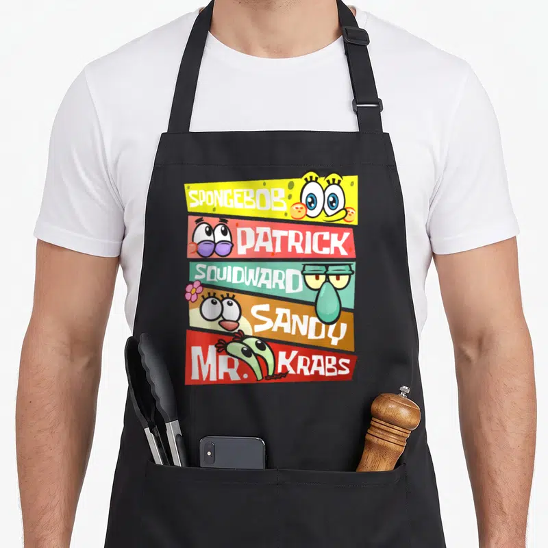 Patrick mr apron - Five colored banners with SpongeBob, Patrick, Squidward, Sandy, Mr. Krabs names and cartoon eyes — shown on a black cotton canvas apron against a white background