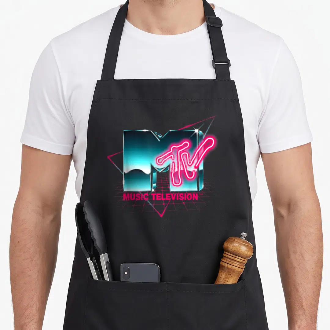 Chrome 80s apron - Teal chrome 3D M with neon pink TV text and MUSIC TELEVISION lettering on a grid — shown on a black cotton canvas apron against a white background