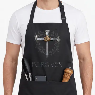 Forgiven minister apron - Cross of three silver nails tied with brown rope before grey crown of thorns above FORGIVEN — shown on a black cotton canvas apron against a white background