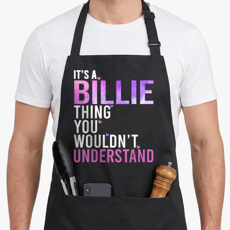 Billie groovy personalized for women apron - Stacked text IT'S A BILLIE THING YOU WOULDN'T UNDERSTAND in white pink — shown on a black cotton canvas apron against a white background