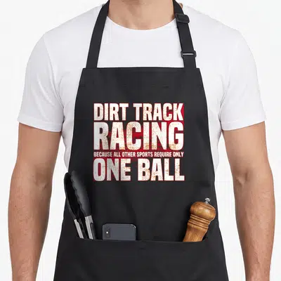 Gear track apron - Distressed white and red text reading Dirt Track Racing Because All Other Sports Require Only One — shown on a black cotton canvas apron against a white background