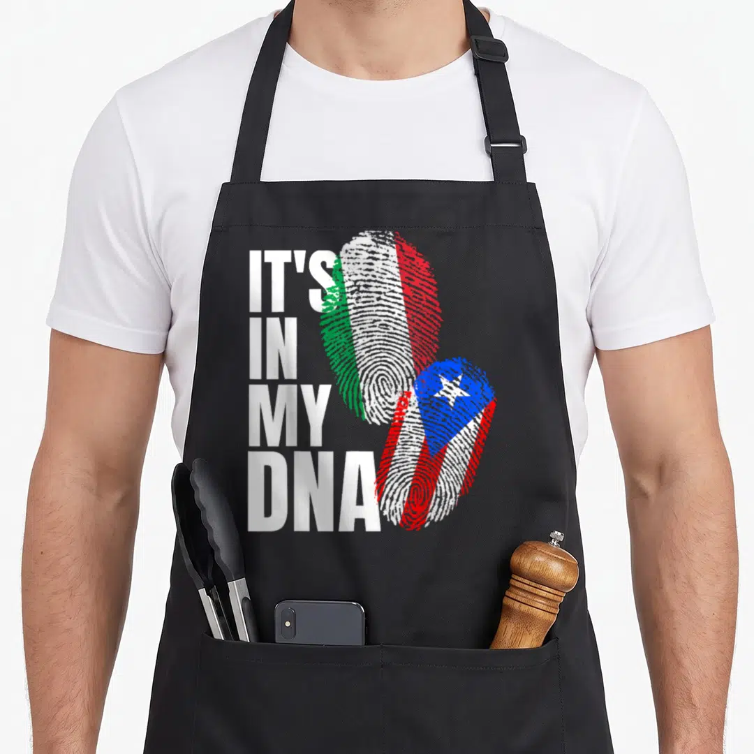 Puerto italian flag apron - Stacked IT'S IN MY DNA text beside two fingerprints filled with Italian and Puerto Rican — shown on a black cotton canvas apron against a white background