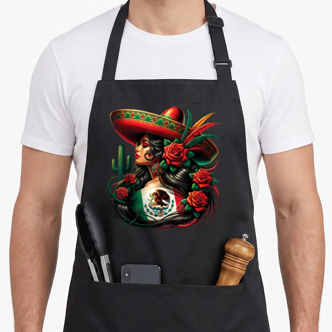 Siesta mexico apron - Woman in profile with sombrero, Mexican flag shawl, red roses, and cactus in red, green, black — shown on a black cotton canvas apron against a white background